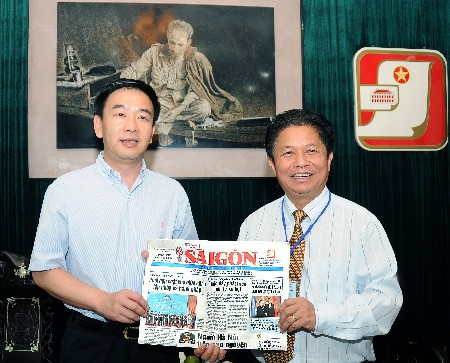 SGGP Editor-in-Chief Tran The Tuyen (R) offers the SGGP publication to Yunnan Daily Press Group Editor-in-Chief Luo Jie. (Photo:SGGP) SGGP Editor-in-Chief Tran The Tuyen (R) offers the SGGP publication to Yunnan Daily Press Group Editor-in-Chief Luo Jie. (Photo:SGGP)